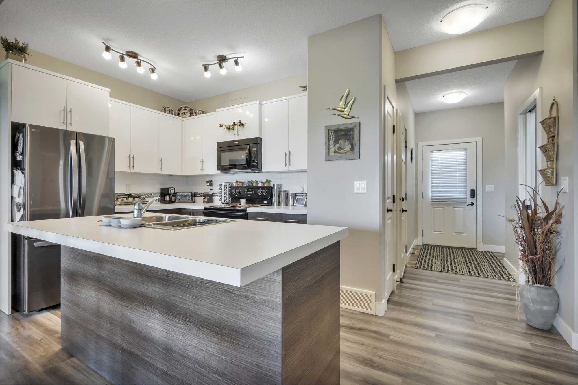 Immaculate & Affordable 2 Story Home ~ Single Attached Garage ~ Condo ~ No Yard Work ~ Backing Onto Green Space ~ In Lacombe 2