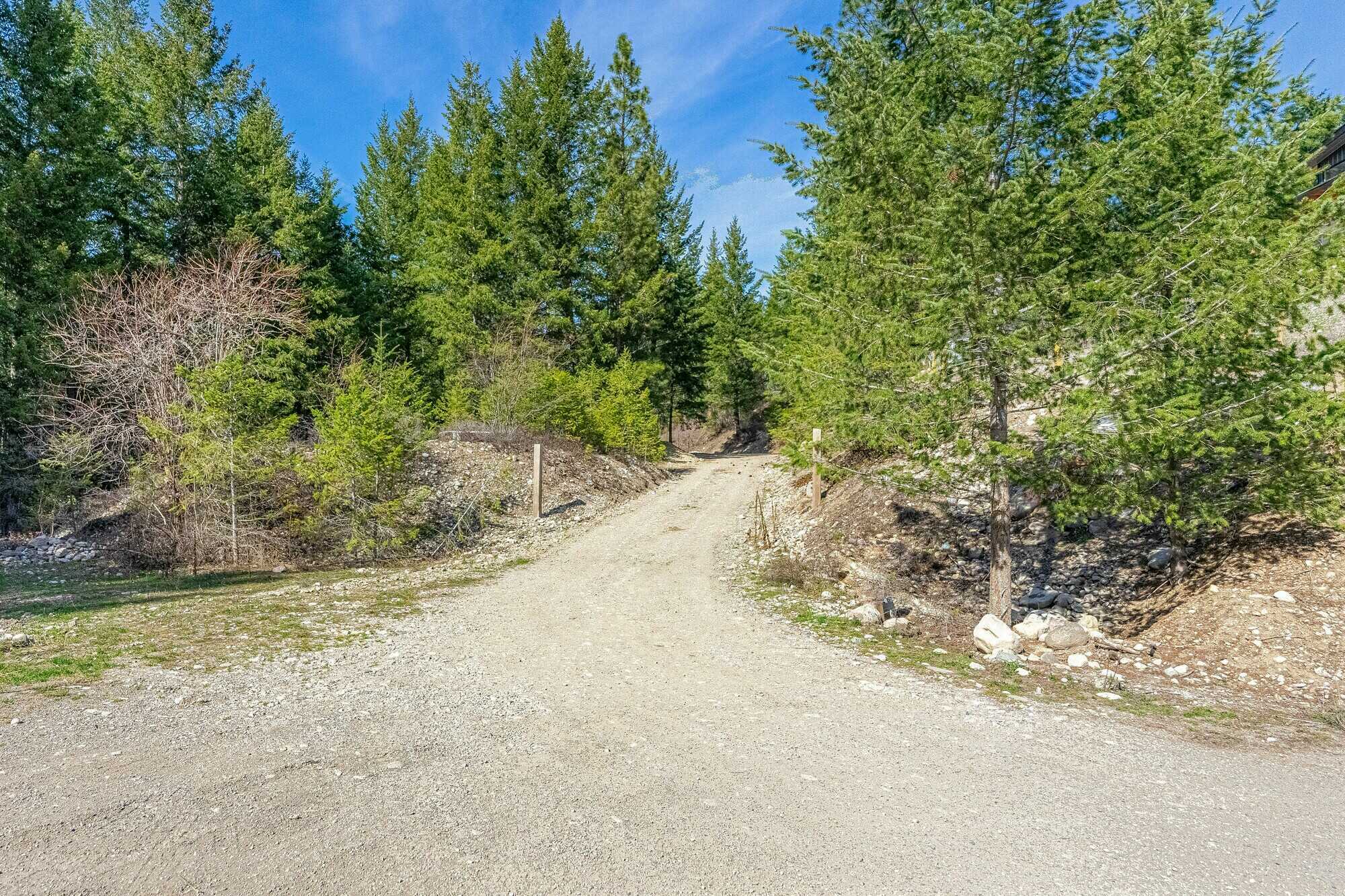 Beautiful, Open, Flat 2 acre lot in the heart of the Okanagan! Stones throw to the beach and backs onto crown land! 3