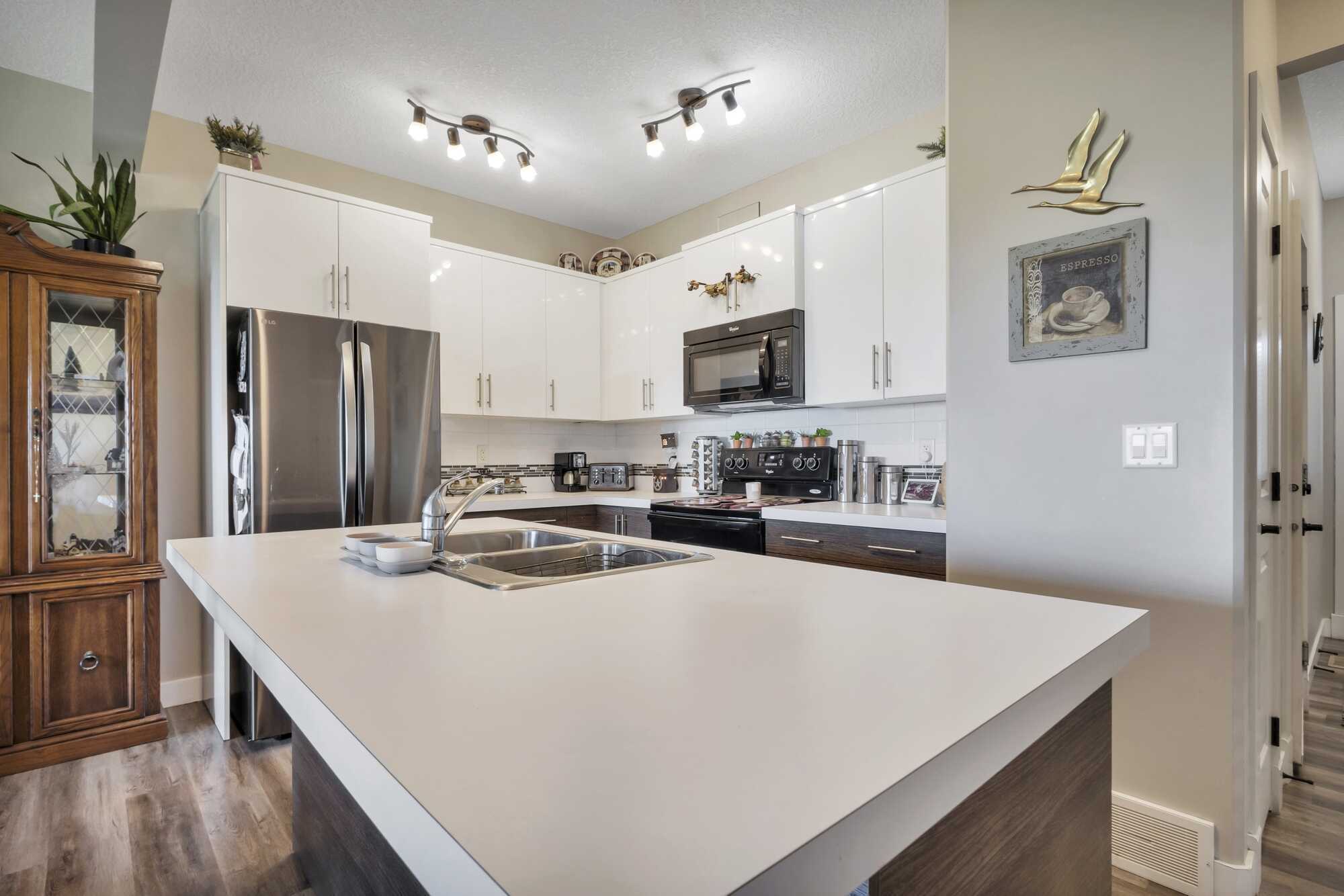 Immaculate & Affordable 2 Story Home ~ Single Attached Garage ~ Condo ~ No Yard Work ~ Backing Onto Green Space ~ In Lacombe 4