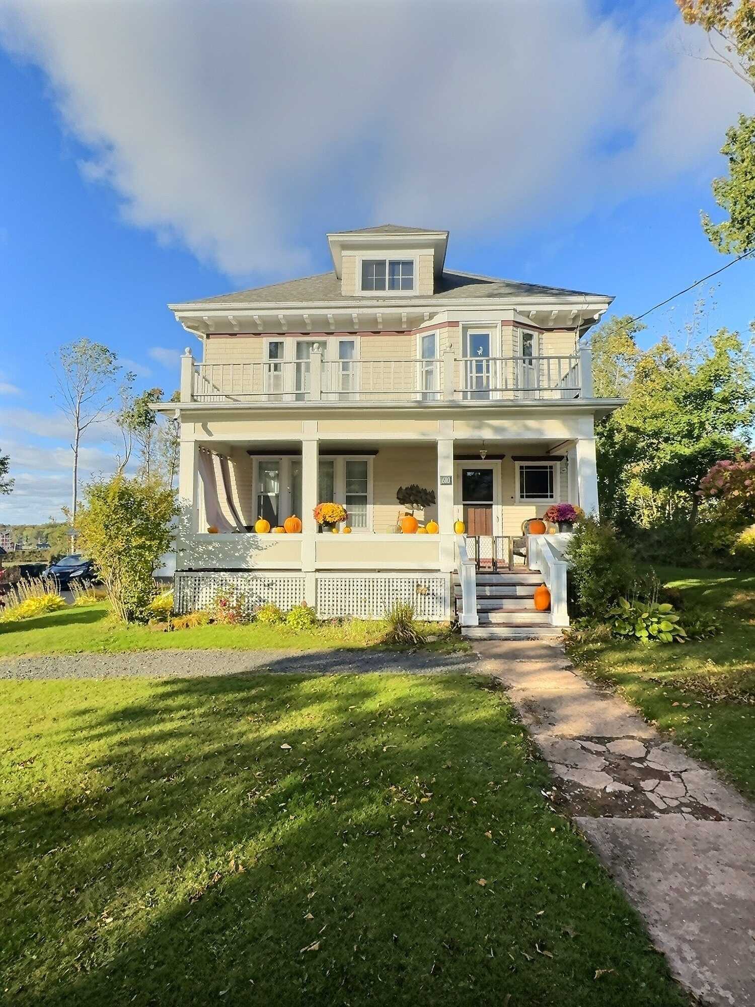 Stately historic home with modern amenities seamlessly blended and a partial water view! 2