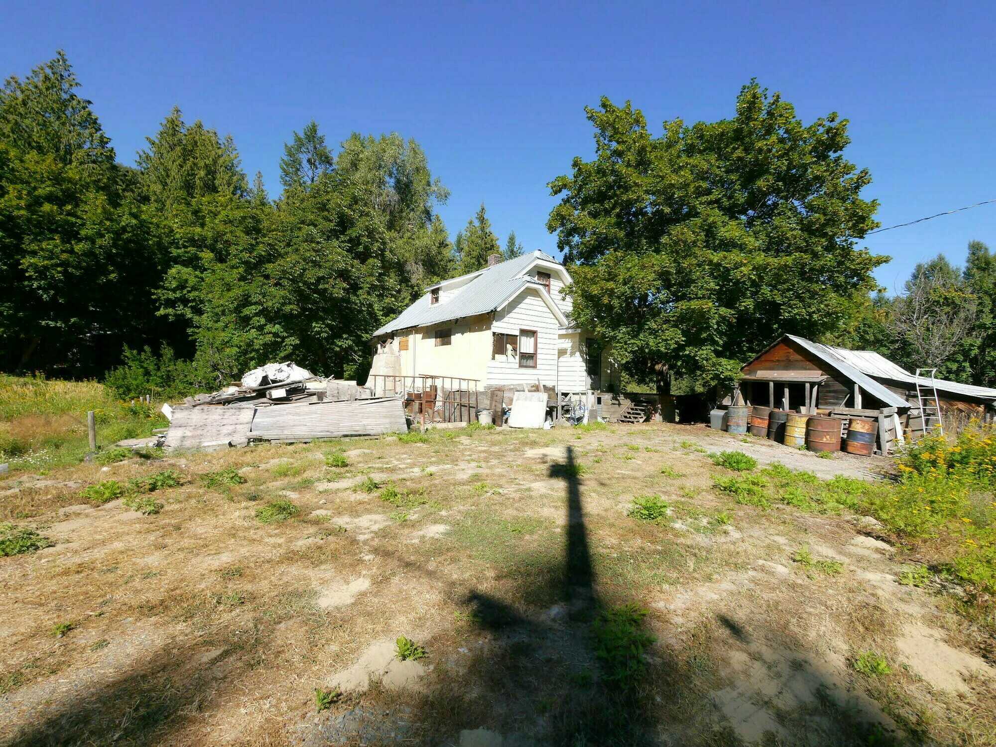 POTENTIAL DEVELOPMENT!  PROJECT PROPERTY!  4Bed 1Bath home looking for love from someone who loves a challenge!  2 Titles and 0.5 acres approximately with a large outbuilding on a No Thru Road! 2