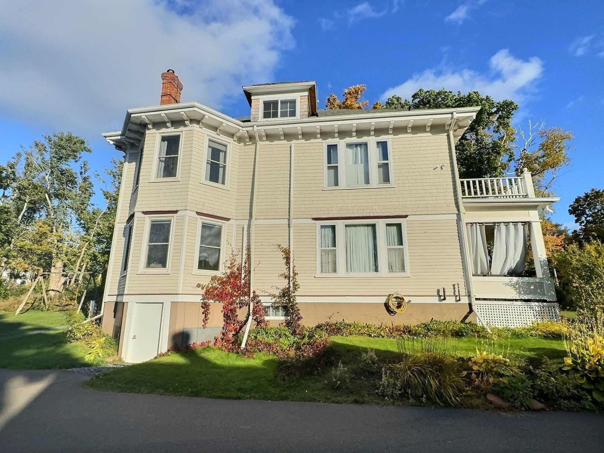 Stately historic home with modern amenities seamlessly blended and a partial water view! 4