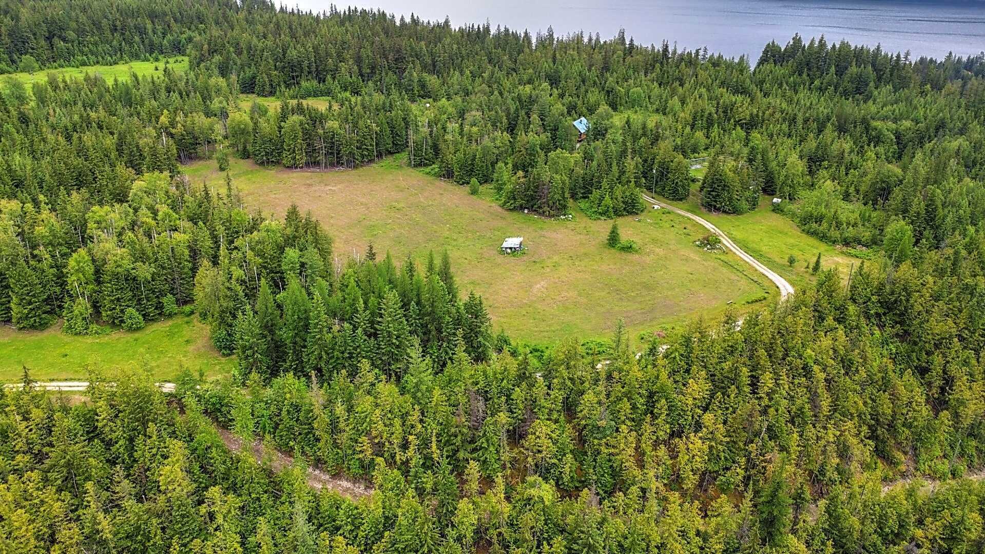 APPROX 28 ACRES! Stunning location! GORGEOUS 4Bed 2Bath Home! 2 min drive to Slocan Lake! Studio building! Potential Farm! 3