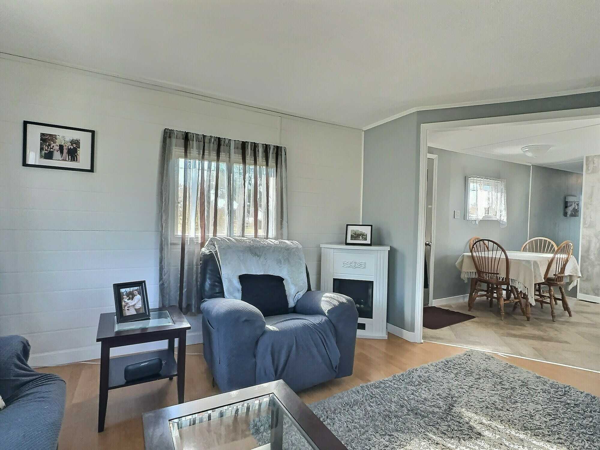 Attention first-time home buyers or downsizers! This move-in-ready two-bedroom mini home offers affordable comfort on a beautifully landscaped 0.71-acre lot. 4