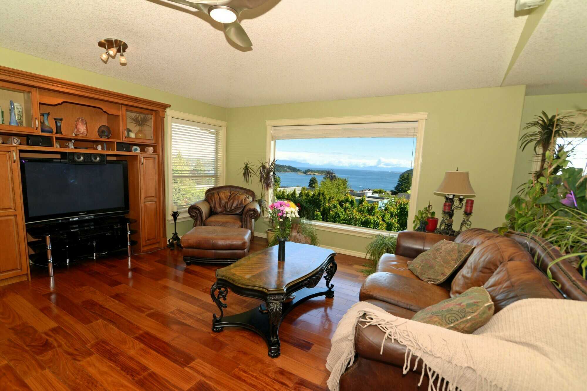 Price Reduced. Ocean and Mountain view 3900 sq. ft. 6 bedroom + Office/Den 4 bathroom family home with Legal suite. 3
