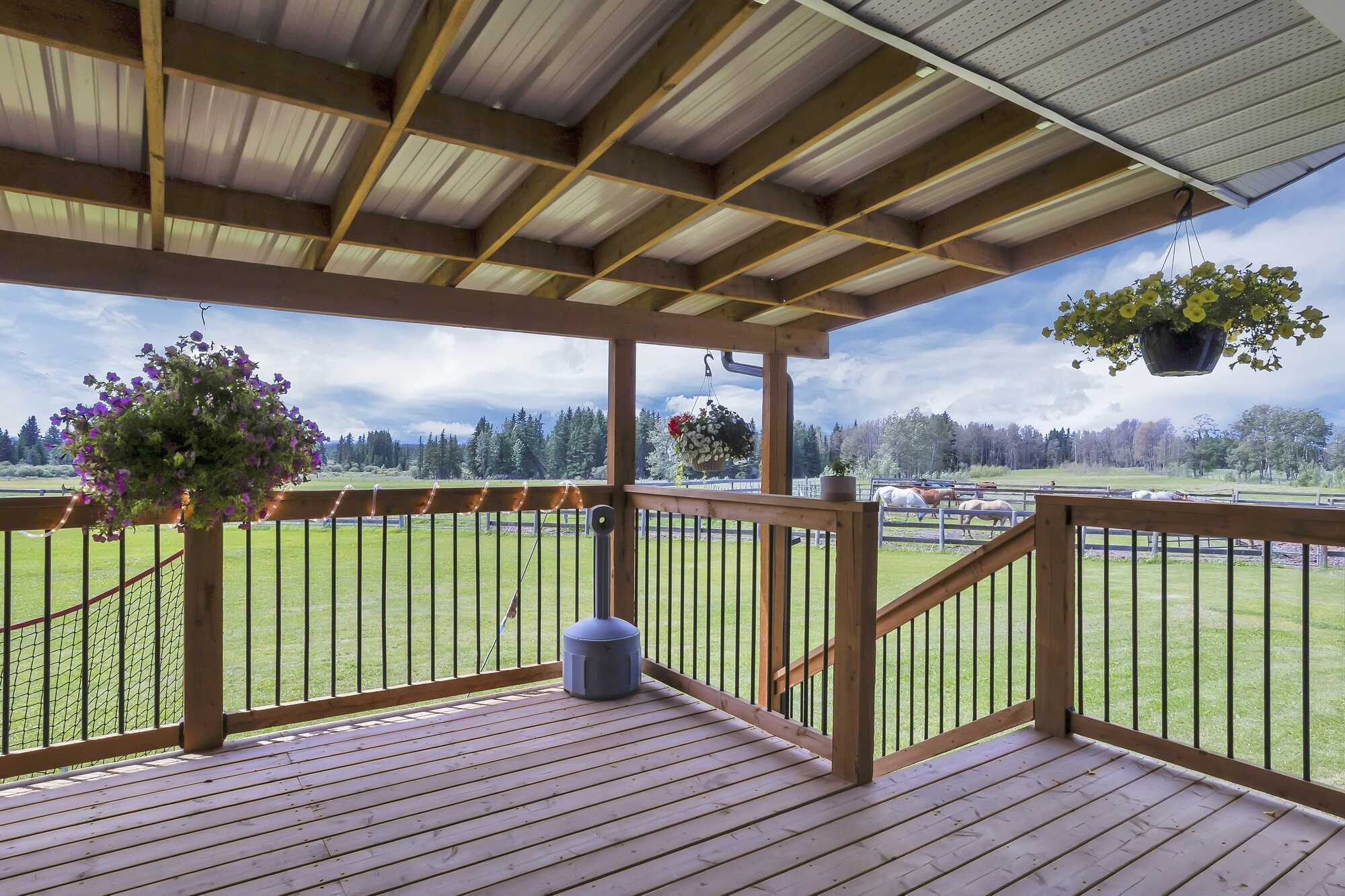78.9 Acres ~ Mountain Views ~ Bungalow with Wrap Around Deck ~ Double Detached Garage ~ Oil Revenue ~ 5 minutes to Rocky ~ on Pavement 5