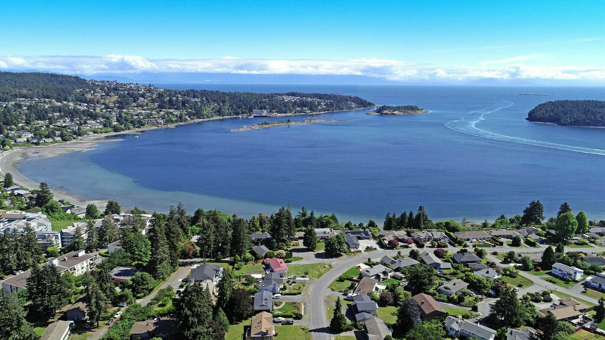 Price Reduced. Ocean and Mountain view 3900 sq. ft. 6 bedroom + Office/Den 4 bathroom family home with Legal suite. 4