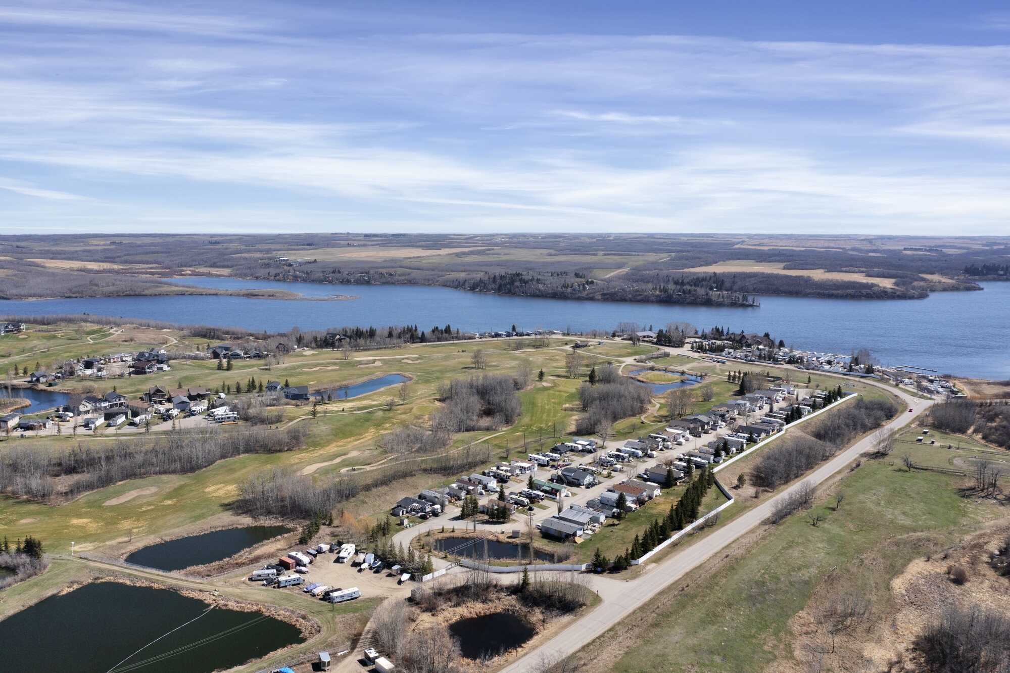 IMMEDIATE POSSESSION! PRICE REDUCED! Lake life at one of Alberta's most sought-after lakes & golf communities!This lake lot includes a 2019 Keystone Cougar 5th wheel Trailer & more ~ Whispering Pines Golf and Country Club Resort ~ 18 Hole Golf Course 2