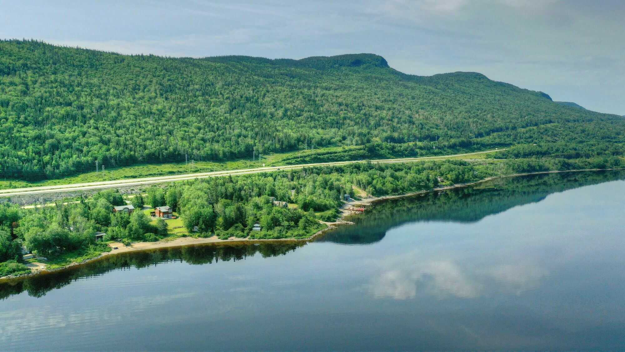 Located between Pasadena and Little Rapids in the heart of the Humber Valley. This unique one-acre lakefront property sits in a cove sheltered from the prevailing westerly wind and slopes gently down to a secluded beach. 3