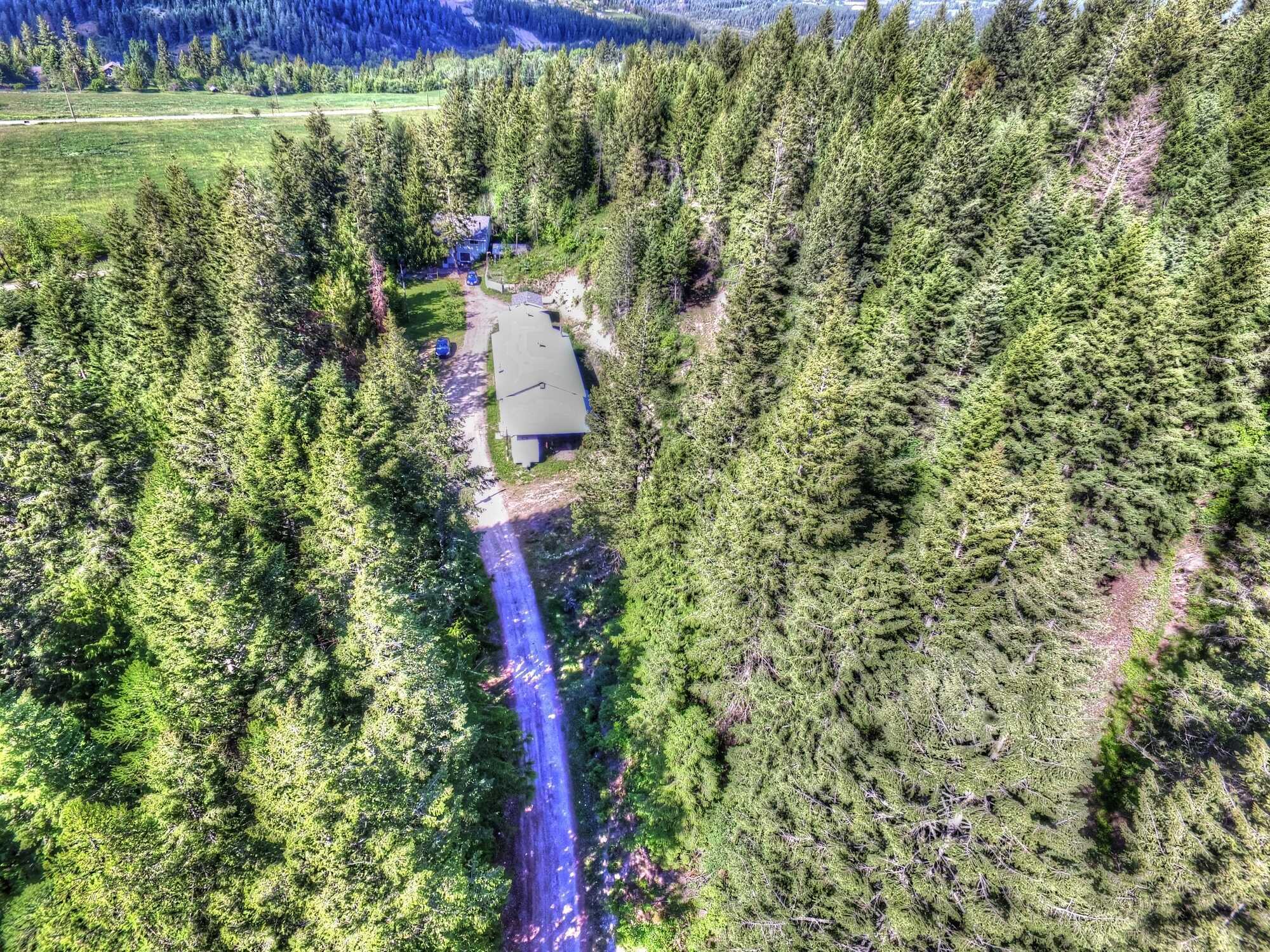 SELF-SUFFICIENCY ON PRIVATE 6 ACRES WITH HOME BASED BUSINESS POTENTIAL.  Super energy efficient spacious home and large shops to meet all your needs. 2