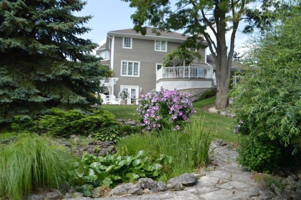 VTB MORTGAGE AT BELOW MARKET RATES on Georgian Bay waterfront property with Pier and Concrete Dock located in prestigious Sutacriti Park.   Manicured landscaping with Pond.  Nearly 3400 sq ft of luxury living space with separate entry In-law Suite. 2