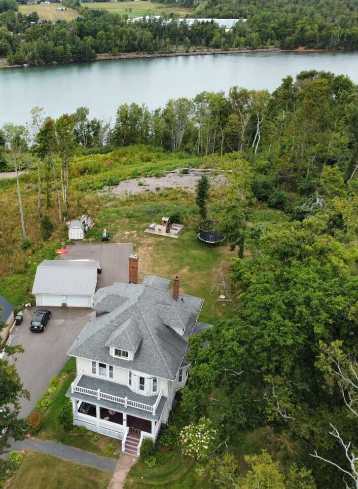 Stately historic home with modern amenities seamlessly blended and a partial water view! 3