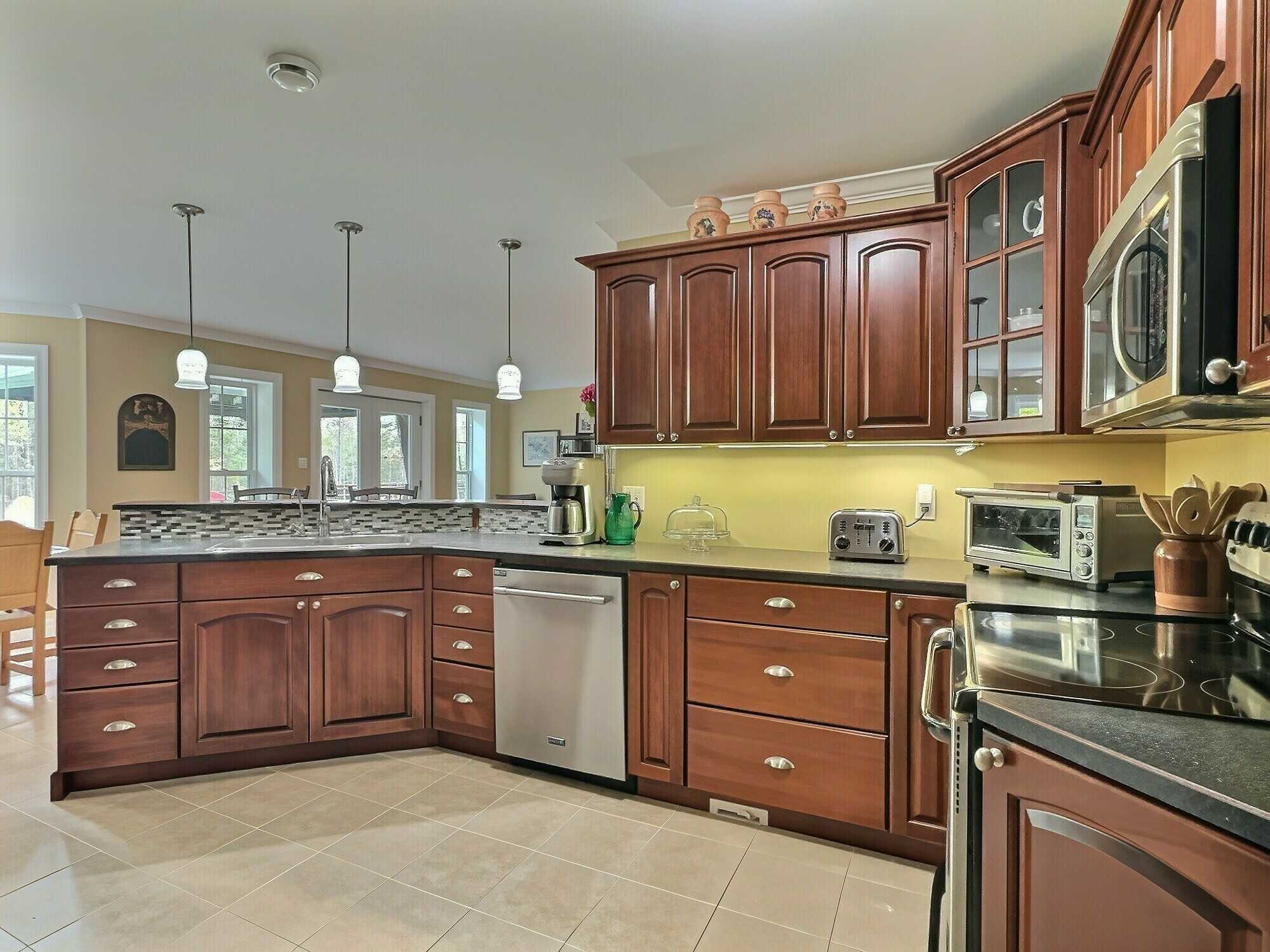 Enjoy easy one-level living on 2.30 private acres backing onto Fox Hollow Golf Course! 5