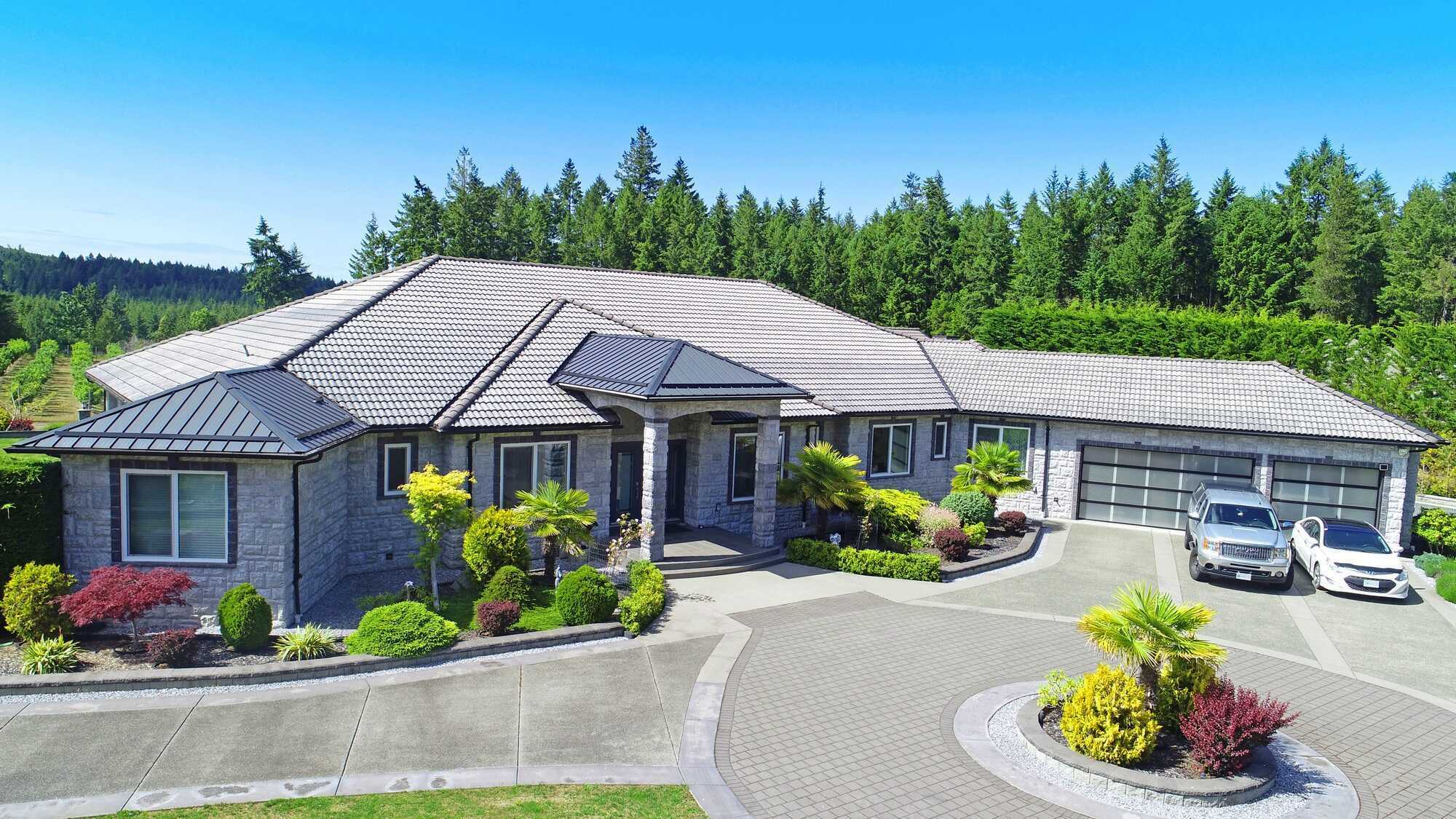 Just Listed ! This Stunning 5,492 sq.ft modern custom-built 4 beds 4 bath home could be yours ! Includes a 1200 sq.ft. attached 2 bed 2 bath Addition on close to 3 acres of property with a beautiful orchard by Englishman River ! 5