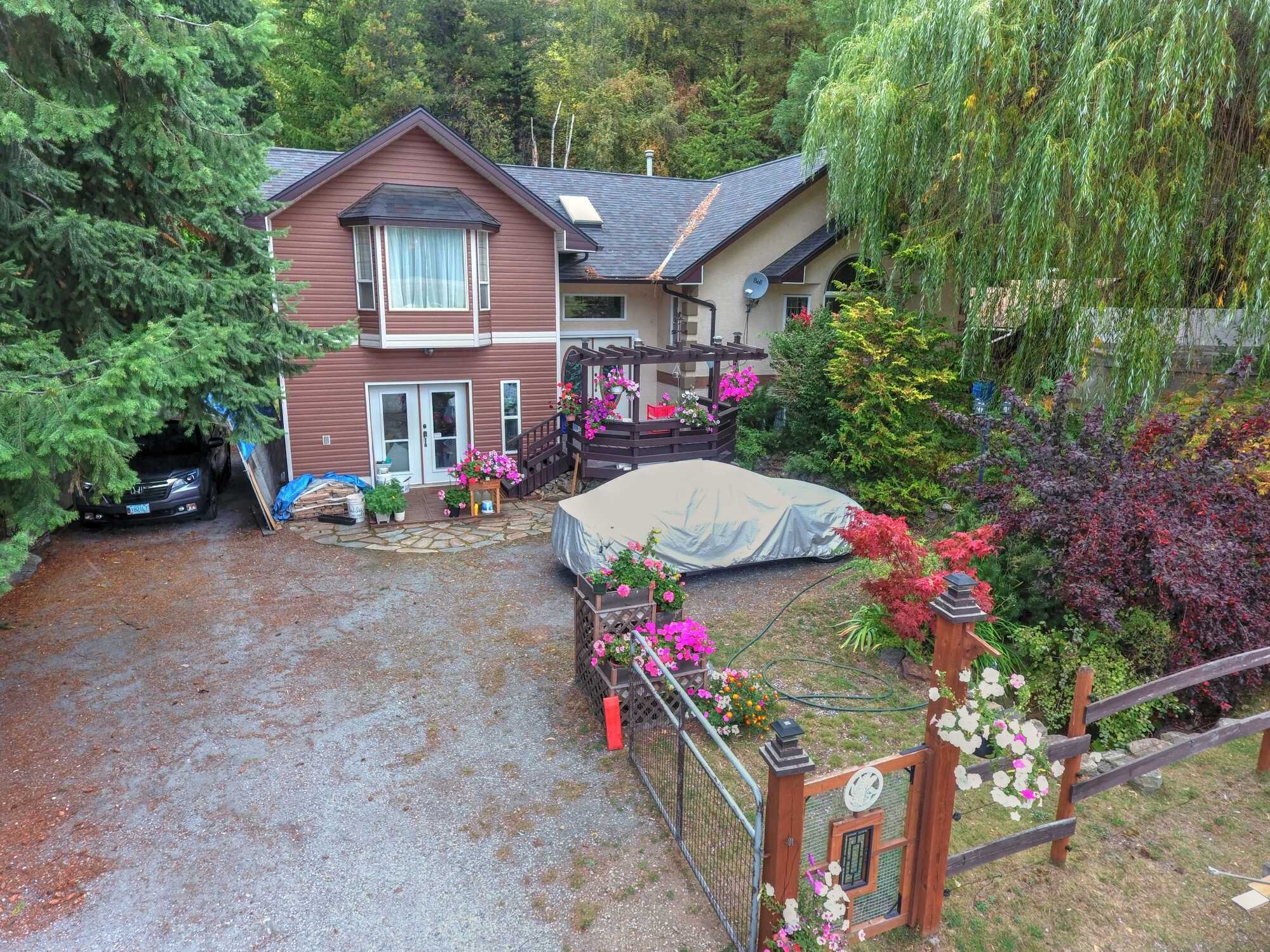 CALL DIRECTLY for INQUIRIES  250-693-2328   *UNIQUE CUSTOM built multi level FAMILY Home & Shop on nearly 2 acres of landscaped paradise! Extremely private!  Located in Genelle! No Backyard Neighbours! 2
