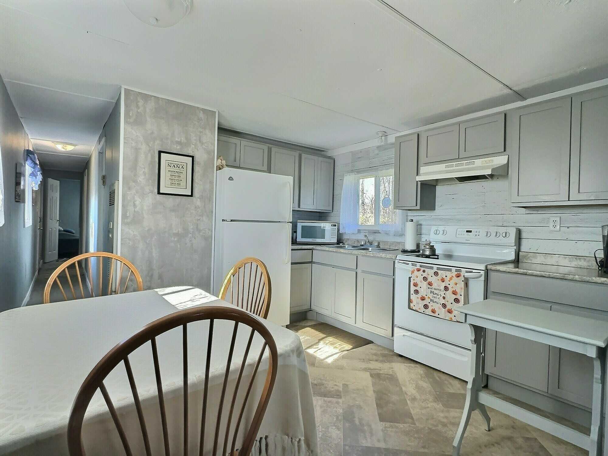 Attention first-time home buyers or downsizers! This move-in-ready two-bedroom mini home offers affordable comfort on a beautifully landscaped 0.71-acre lot. 5