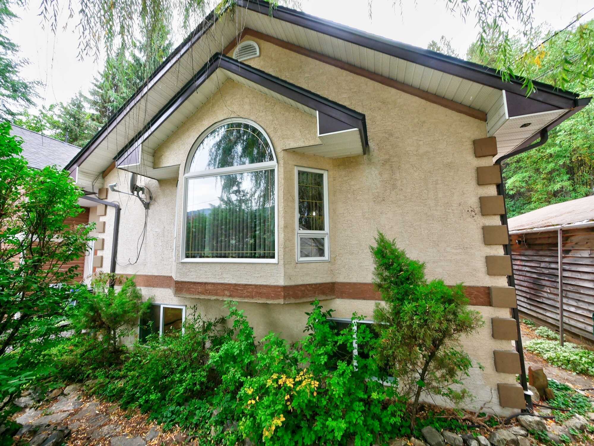 CALL DIRECTLY for INQUIRIES  250-693-2328   *UNIQUE CUSTOM built multi level FAMILY Home & Shop on nearly 2 acres of landscaped paradise! Extremely private!  Located in Genelle! No Backyard Neighbours! 3