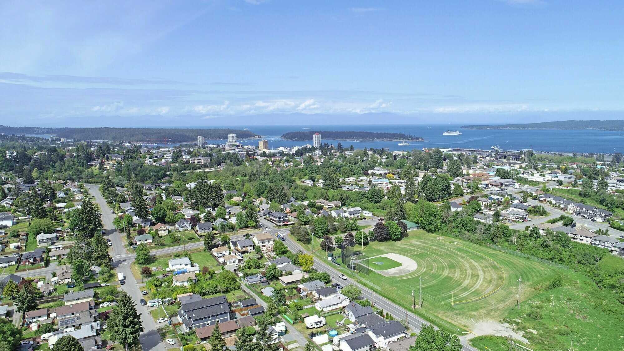 NEWLY PRICED ! 2 lots & 1 house assessed at $885,000.
NOW reduced to $750,000! 
Prime Opportunity to Build Multiple Homes on these Zone 5 High Density lots! Realtors welcome !  Located in Nanaimo BC this 3 bedroom 2 bathroom home is waiting for you ! 2