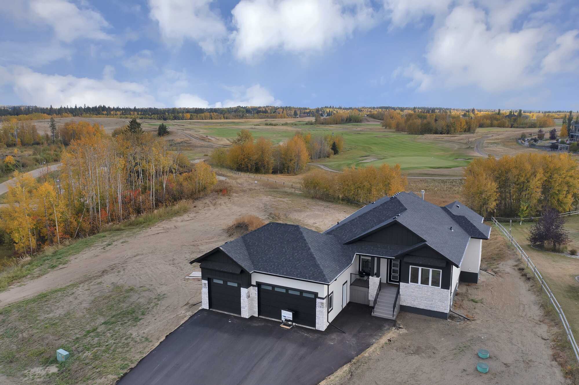 Golf Course Living at Its Finest – Brand New ~ Executive Walkout Bungalow ~ Triple Garage ~  In Sought After Wolf Creek Village 2