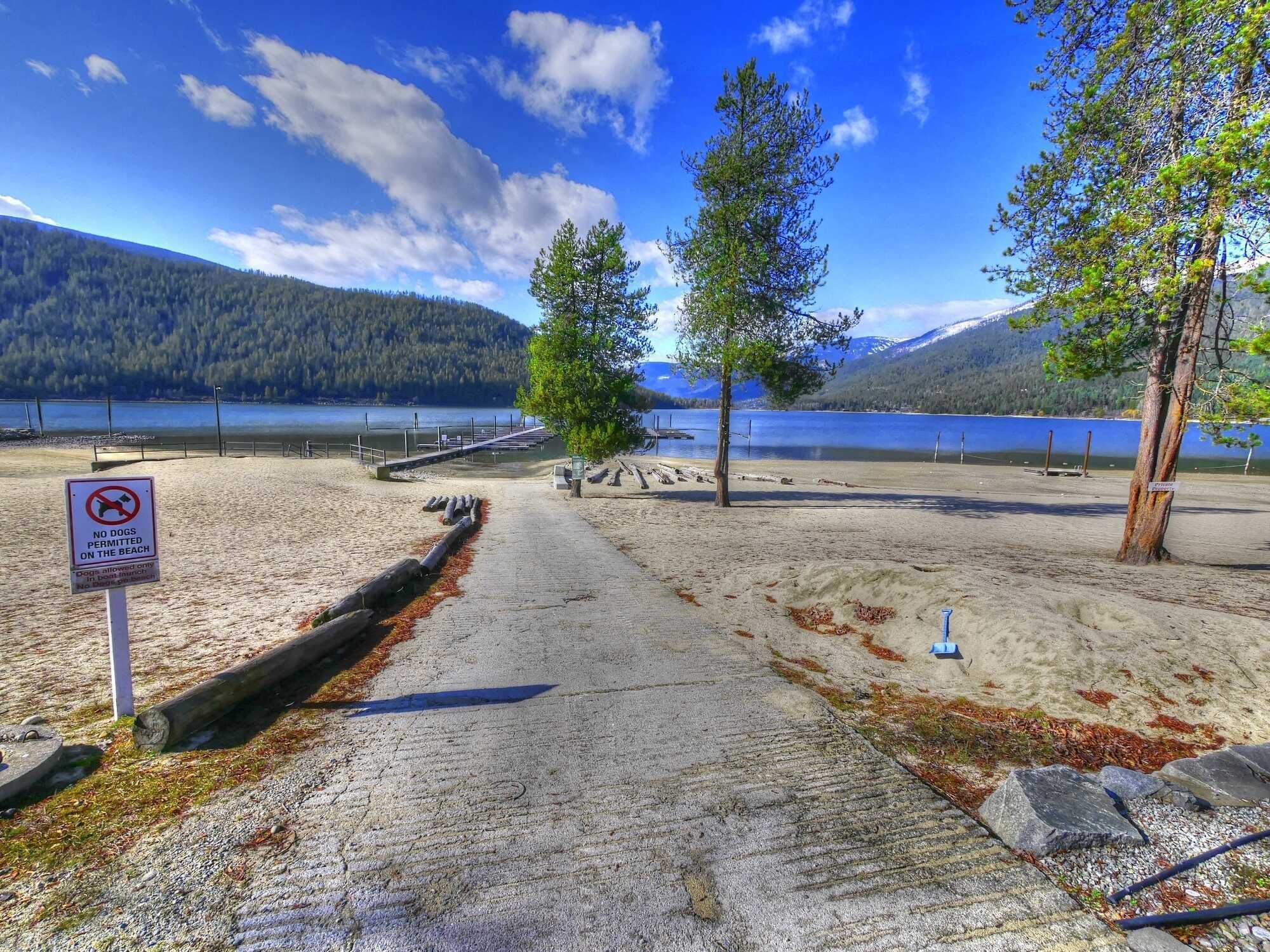 Next to Kootenay Lake!  VACATION PROPERTY - LARGE LOT! NEW MARINA BY 2026 Private and ideal for the summer getaways! Hookups for RV or TINY HOME or put in a MODULAR HOME! 5