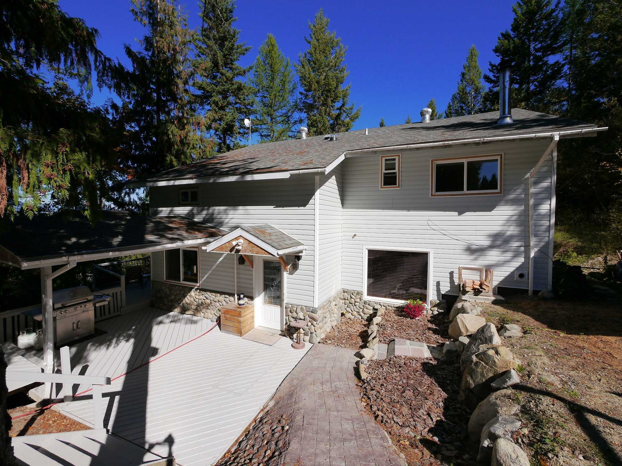 SELF-SUFFICIENCY ON PRIVATE 6 ACRES WITH HOME BASED BUSINESS POTENTIAL.  Super energy efficient spacious home and large shops to meet all your needs. 3