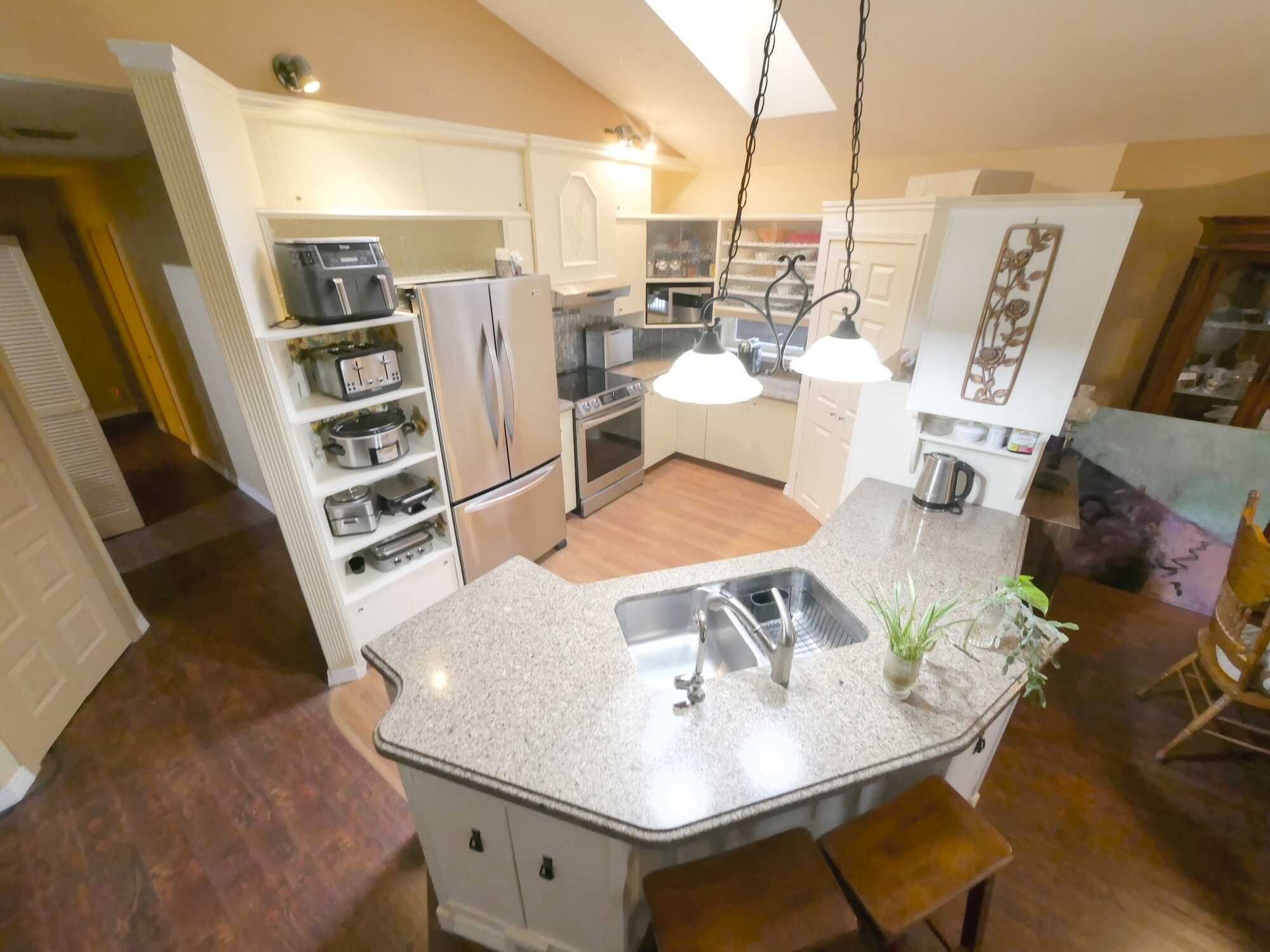 CALL DIRECTLY for INQUIRIES  250-693-2328   *UNIQUE CUSTOM built multi level FAMILY Home & Shop on nearly 2 acres of landscaped paradise! Extremely private!  Located in Genelle! No Backyard Neighbours! 4