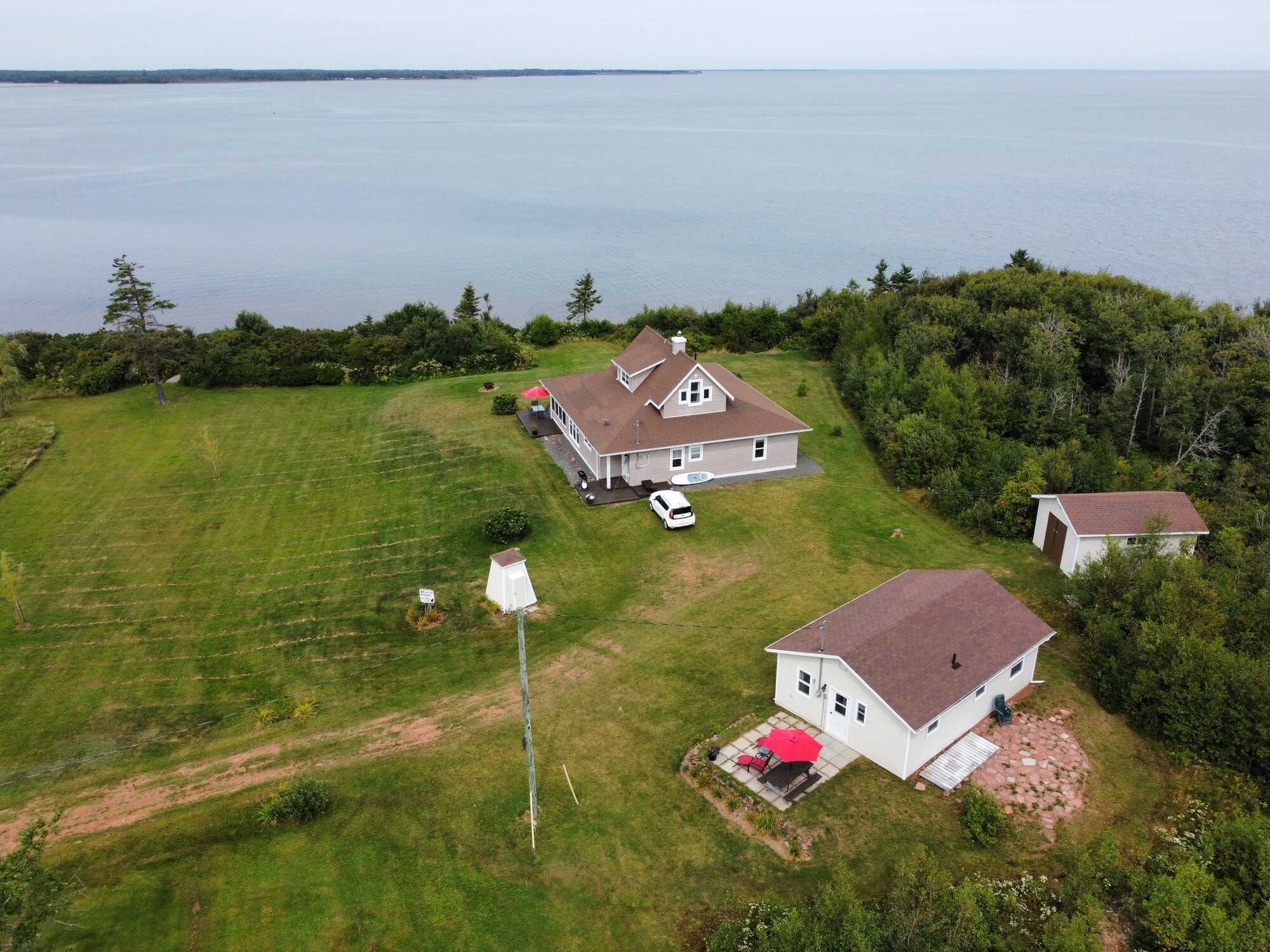 65 Abby Rd. in Beach Point, PE is a picturesque waterfront retreat, perfectly capturing the charm of seaside living. 2