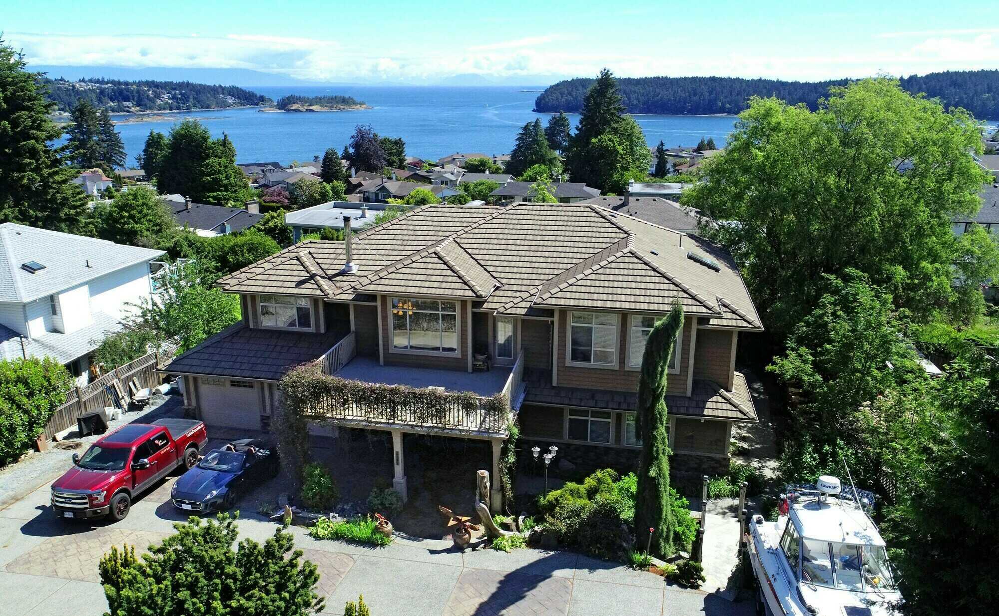 Price Reduced. Ocean and Mountain view 3900 sq. ft. 6 bedroom + Office/Den 4 bathroom family home with Legal suite. 2