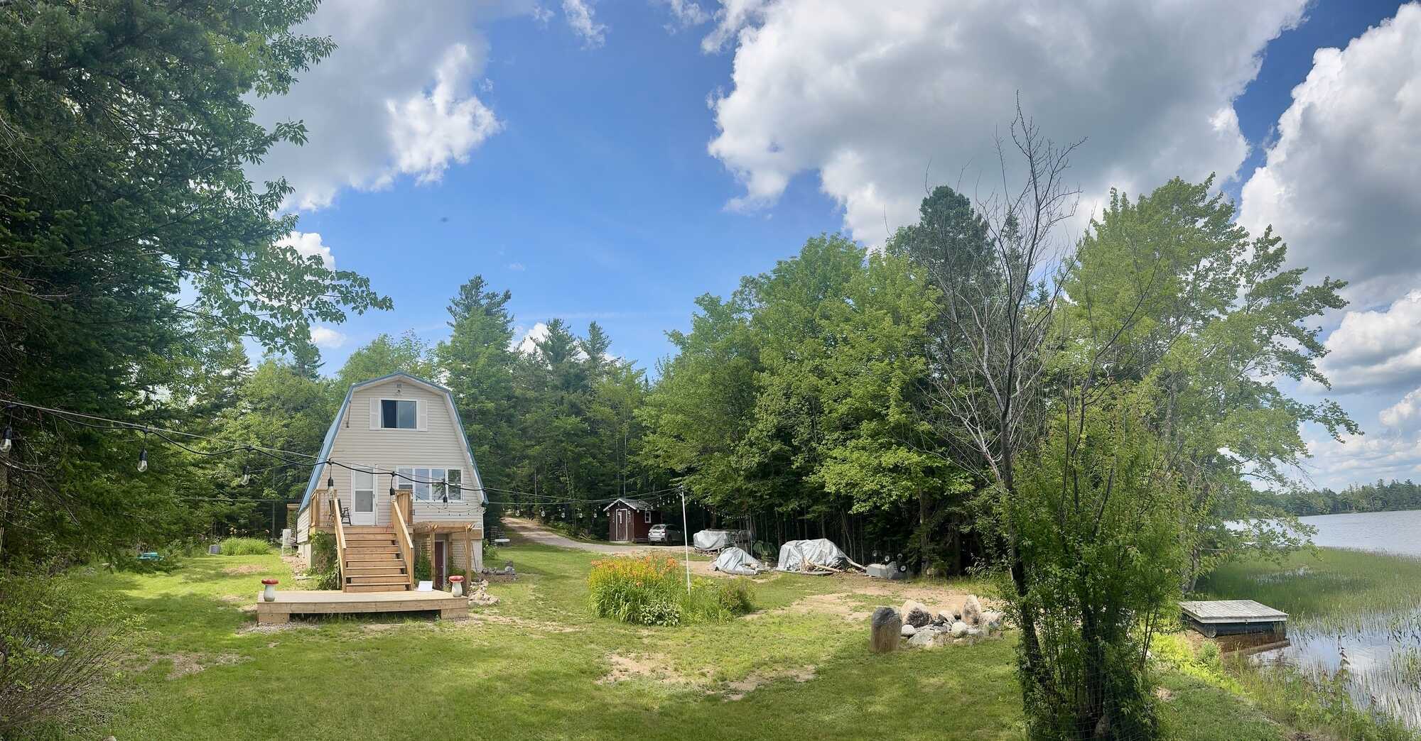 East Dalhousie four season cottage with lake frontage ideal for boat launch! 60x40 field with 200amp wired mini barn, 12x12 geodesic all-season dome, outdoor shower, and new front & back decks- your ideal lakeside retreat! 4