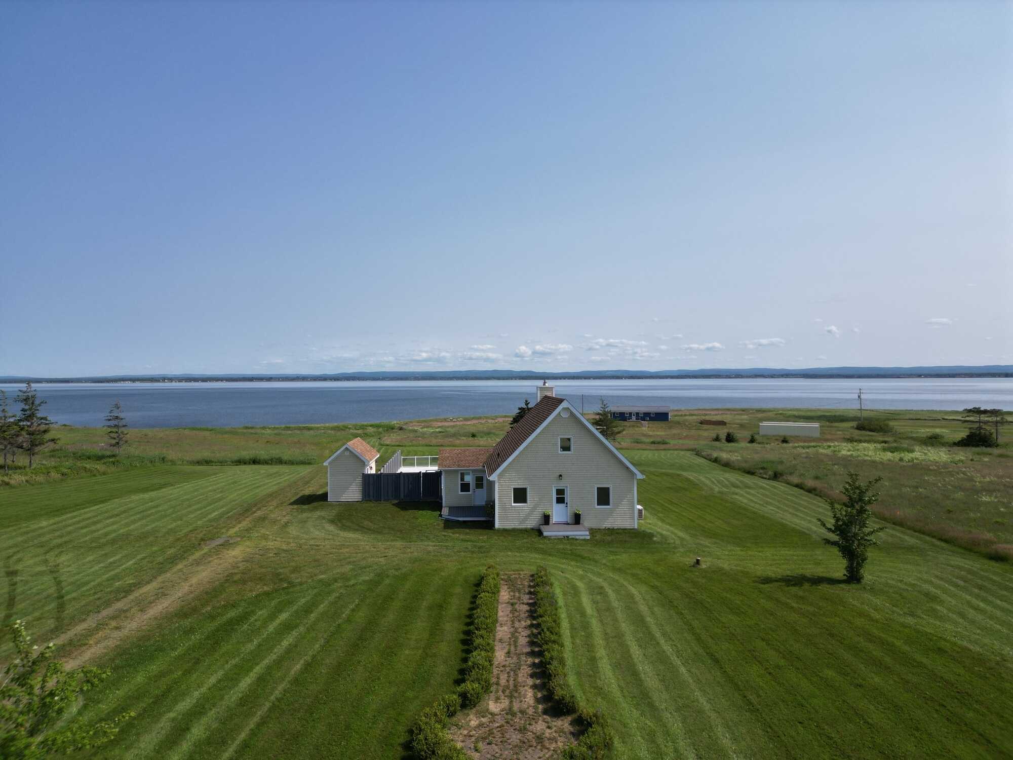 Experience coastal living at its finest with this exceptional executive waterfront estate set on approximately 4 private acres, complete with a secluded beach and breathtaking ocean views! 3