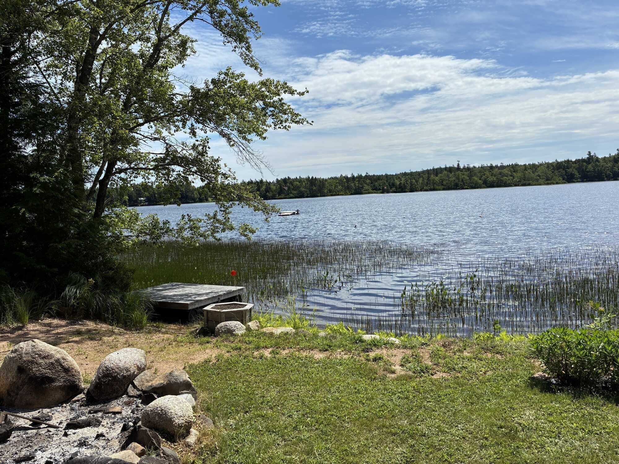 East Dalhousie four season cottage with lake frontage ideal for boat launch! 60x40 field with 200amp wired mini barn, 12x12 geodesic all-season dome, outdoor shower, and new front & back decks- your ideal lakeside retreat! 5