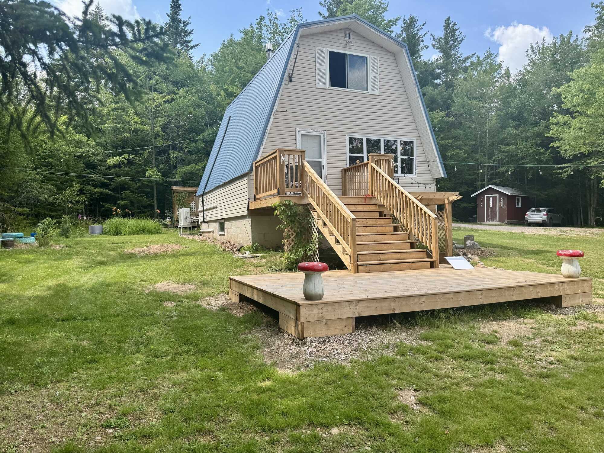 East Dalhousie four season cottage with lake frontage ideal for boat launch! 60x40 field with 200amp wired mini barn, 12x12 geodesic all-season dome, outdoor shower, and new front & back decks- your ideal lakeside retreat! 3