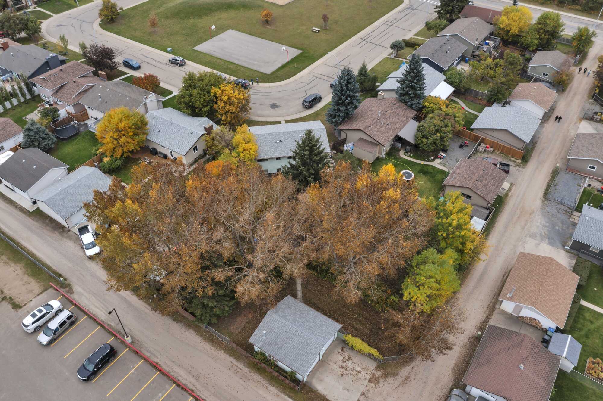 Great Investment Opportunity ~ Pie Shaped Lot ~ Bi-Level ~ 2 Independent Living Spaces ~ Double Detached Heated Garage ~ Across From Green Space 3